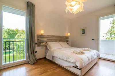 Letto o letti in una camera di enJoy Home - Appartamento ampio, luminoso e immerso nel verde