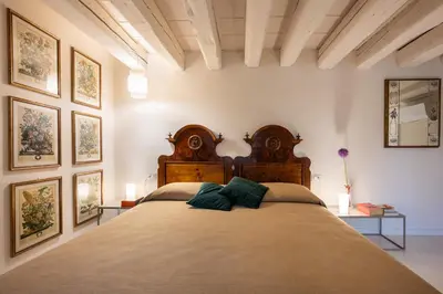 Letto o letti in una camera di Palazzo Borgoloco