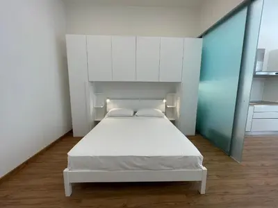 Letto o letti in una camera di JESOLO SPIAGGIA HOLIDAY