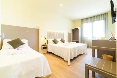 Letto o letti in una camera di Hotel Calaluna