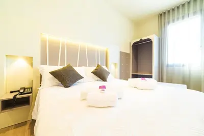Letto o letti in una camera di Hotel Calaluna