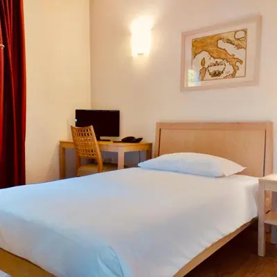 Letto o letti in una camera di Campus San Francesco
