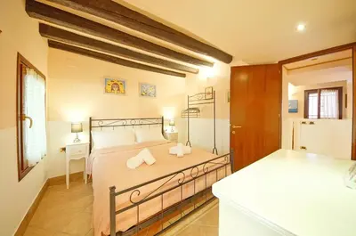 Letto o letti in una camera di Santa Croce WIFI S.G. Dellorio coop