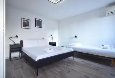 Letto o letti in una camera di Welc-ōM Padova Fiera
