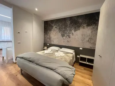 Letto o letti in una camera di PIO X Apartments Treviso