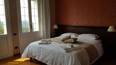 Letto o letti in una camera di Villa Lussana