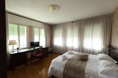 Letto o letti in una camera di Villa Lussana