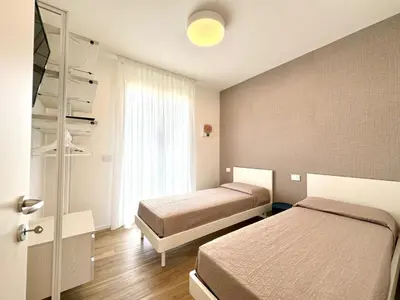 Letto o letti in una camera di Sun Village-Nuovissimo Appartamento in Residence con piscina -Lido di Jesolo Piazza Aurora