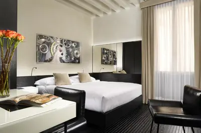 Letto o letti in una camera di Hotel L'Orologio Venezia - WTB Hotels