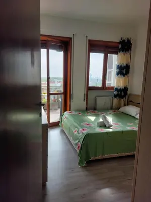 Letto o letti in una camera di Punto FM