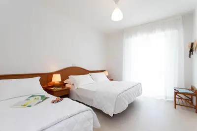 Letto o letti in una camera di Hotel Mirafiori