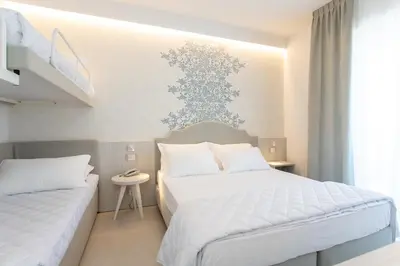 Letto o letti in una camera di Hotel Mirafiori