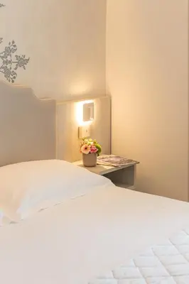 Letto o letti in una camera di Hotel Mirafiori