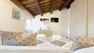 Letto o letti in una camera di Casa Vianello Cri by Ca-Sa Check