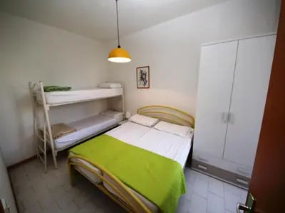 Letto o letti in una camera di Relax in our flat with garden in Rosolina