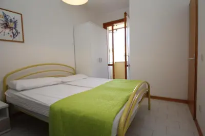 Letto o letti in una camera di Relax in our flat with garden in Rosolina