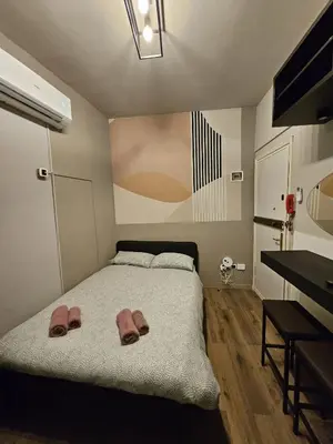 Letto o letti in una camera di Zen Apartments Belzoni