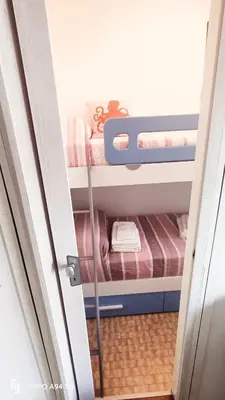 Letto o letti in una camera di Appartamento a due passi dalla spiaggia Apartment Just Steps from the Beach