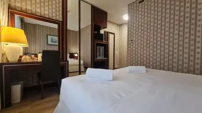 Letto o letti in una camera di Garden Hotel Michelangelo
