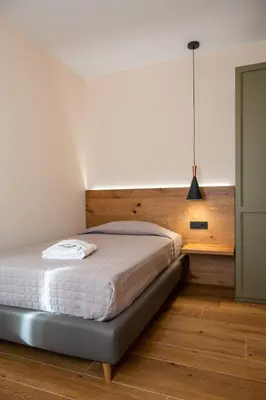 Letto o letti in una camera di AURA Dimore ad Arquà Petrarca