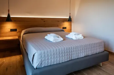 Letto o letti in una camera di AURA Dimore ad Arquà Petrarca