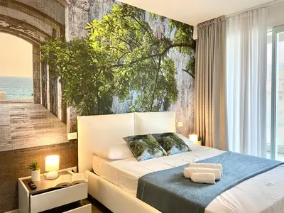 Letto o letti in una camera di Tahiti Suite Frontemare - Jesolo - FAMILY APARTMENT