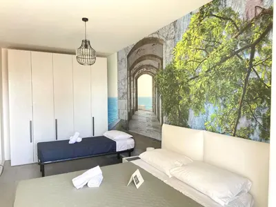Letto o letti in una camera di Tahiti Suite Frontemare - Jesolo - FAMILY APARTMENT