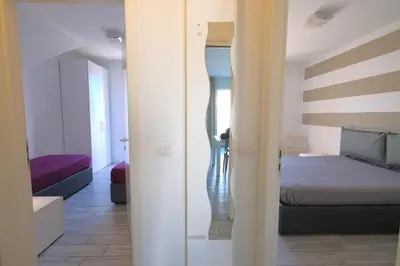Letto o letti in una camera di Wave Village Piazza Trieste