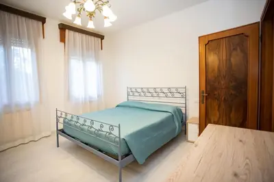 Letto o letti in una camera di Dimora Giannino e Mirella Isola di Pellestrina Ve