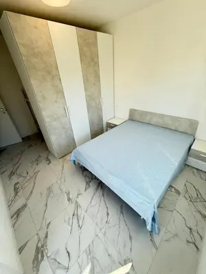 Letto o letti in una camera di WHITE APARTMENTS - Solo per famiglie- WALTERIGATO APARTMENTS