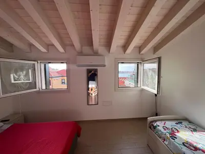 Letto o letti in una camera di Appartamento con vista laguna
