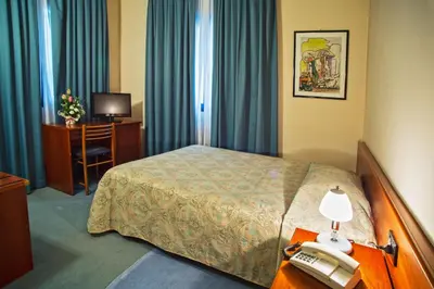 Letto o letti in una camera di Albergo Centrale