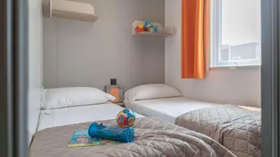 Letto o letti in una camera di Camping Grande Italia