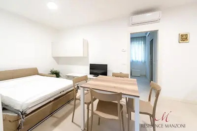 Letto o letti in una camera di Residence Manzoni