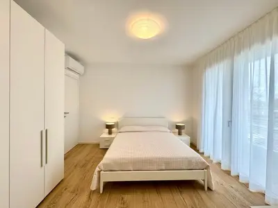 Letto o letti in una camera di J Eight - Carraro Immobiliare - Family Apartments