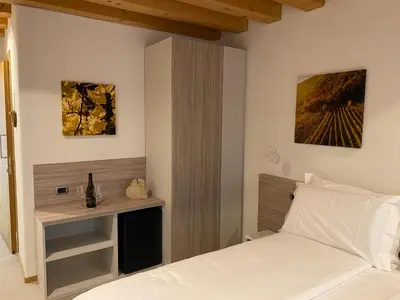 Letto o letti in una camera di Agrialloggio Cantina Piccolin