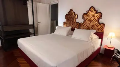 Letto o letti in una camera di Comedia by Suites alla Maddalena