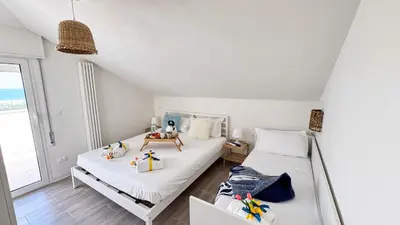 Letto o letti in una camera di Rooftop Blu Infinito by Ca-Sa Check