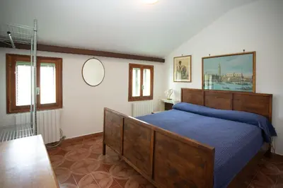 Letto o letti in una camera di Dimora CaGigi Isola di Pellestrina Ve