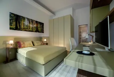 Letto o letti in una camera di Cà Murà - Residence Altinate