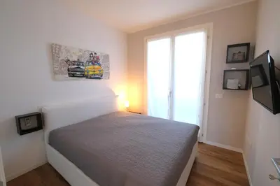 Letto o letti in una camera di Wave Village piano terra Piazza Trieste