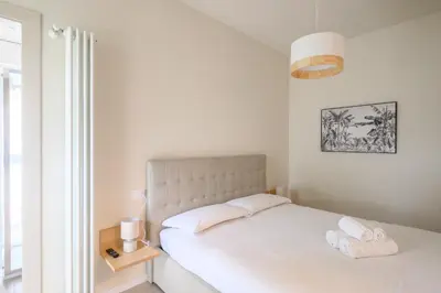 Letto o letti in una camera di GuestHost - Cozy Apt near Basilica Sant'Antonio