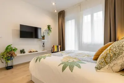 Letto o letti in una camera di Estense Home - near Duomo