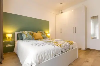 Letto o letti in una camera di Estense Home - near Duomo