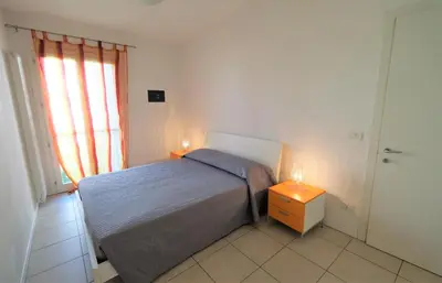 Letto o letti in una camera di Residence Borgo Paradiso posto spiaggia compreso