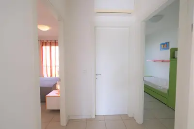 Letto o letti in una camera di Residence Borgo Paradiso posto spiaggia compreso