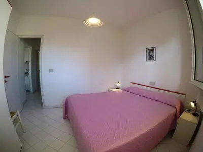 Letto o letti in una camera di Apartments Beachfront in Rosolina Mare 33984