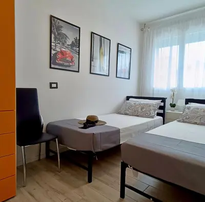 Letto o letti in una camera di GIGI HOUSE appartamento PIAZZA MAZZINI 150m dal mare CON PISCINA e SPIAGGIA