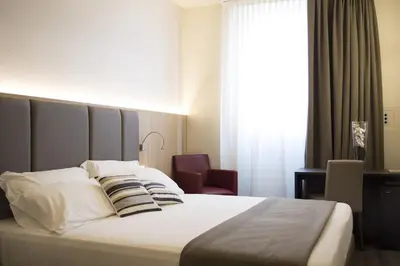 Letto o letti in una camera di Hotel Alexander
