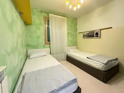 Letto o letti in una camera di BORGO DEI FIORI - Solo per Famiglie-Walterigato Apartments
